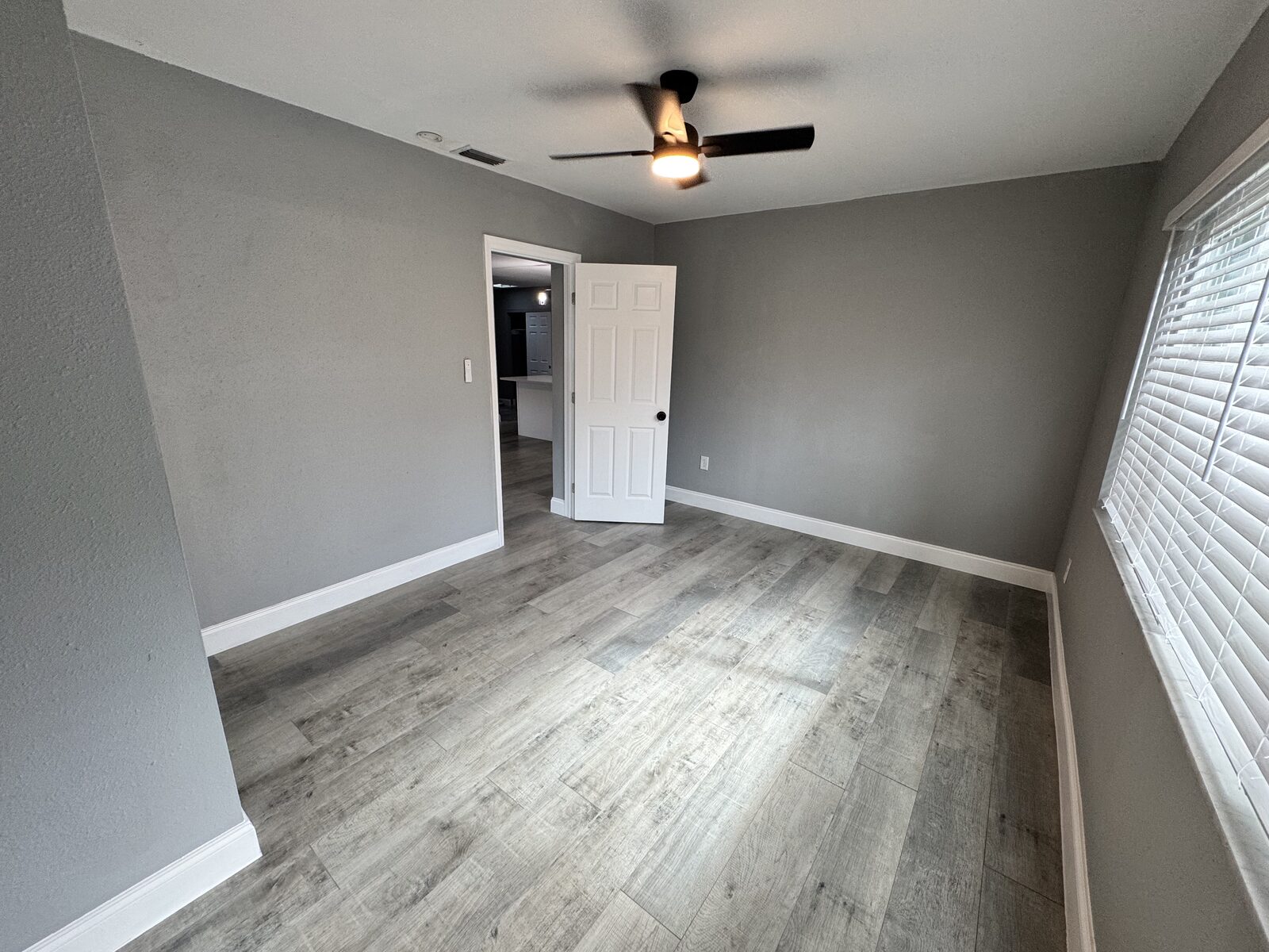 Bedroom with ceiling fan, window and closet