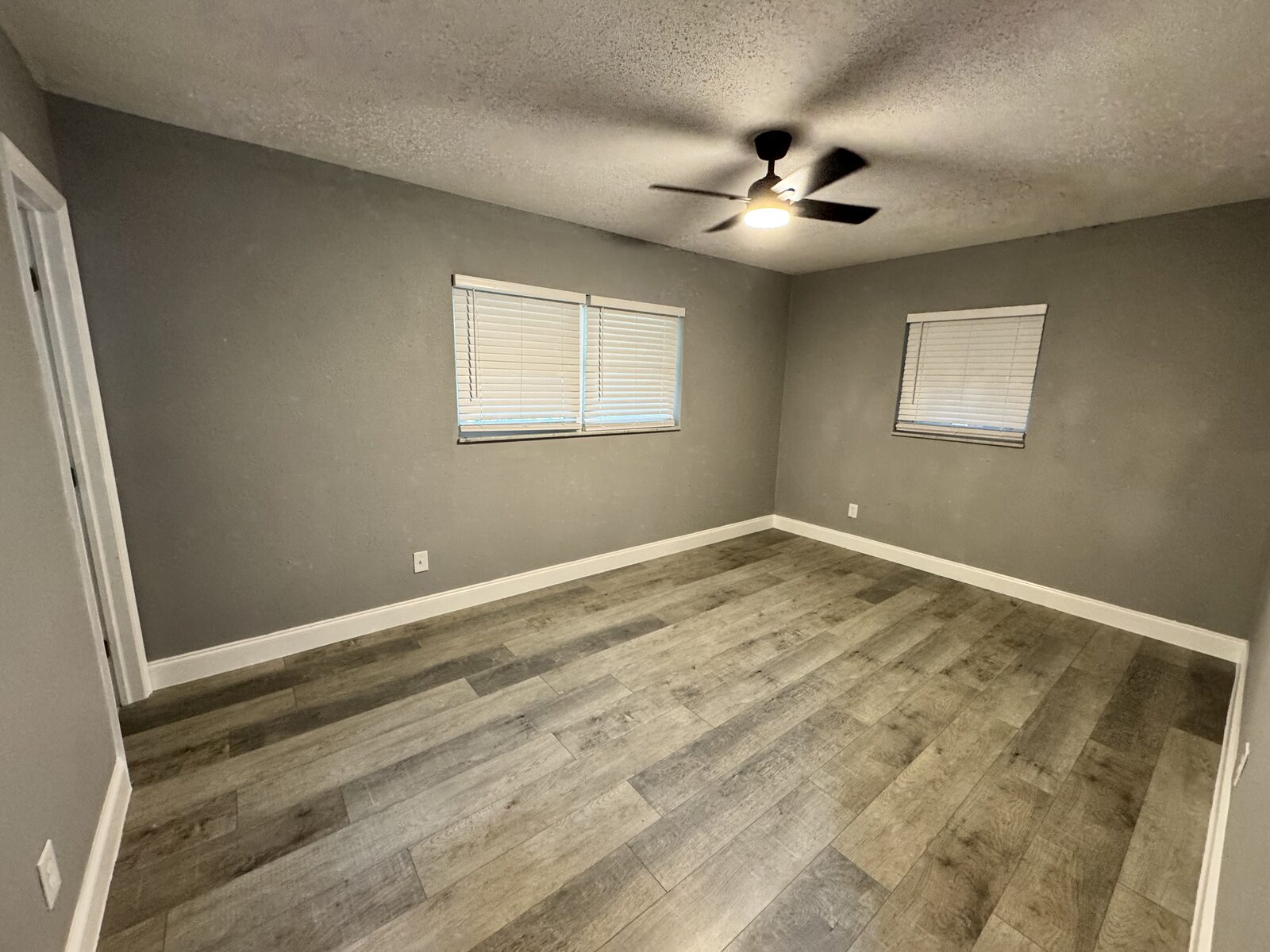 Bedroom with two windows and new flooring