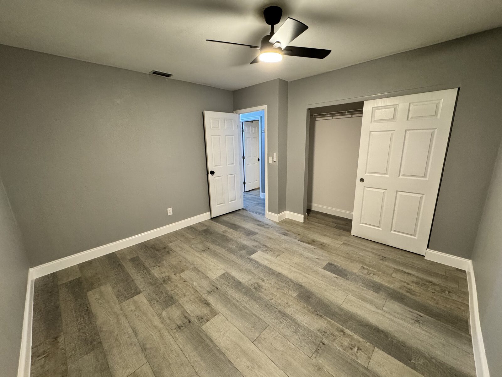 Bedroom with double closet and new plank flooring