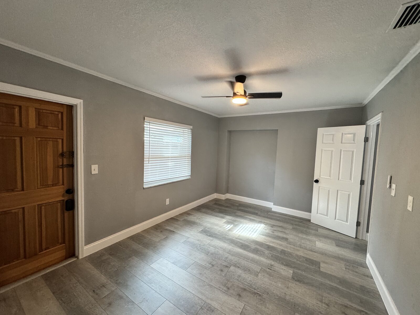 Entry foyer with solid wood front door opening to the living room