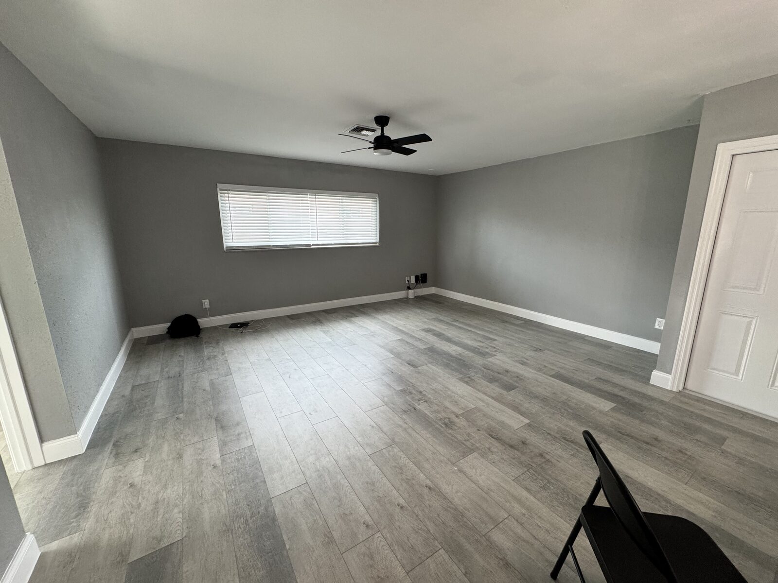 Second living area with natural light and fresh paint