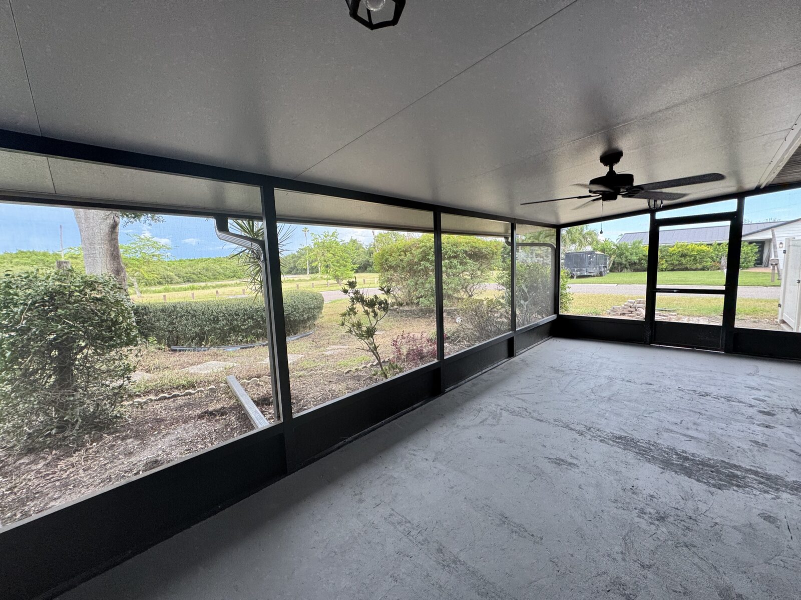 Screened lanai overlooking the fenced backyard