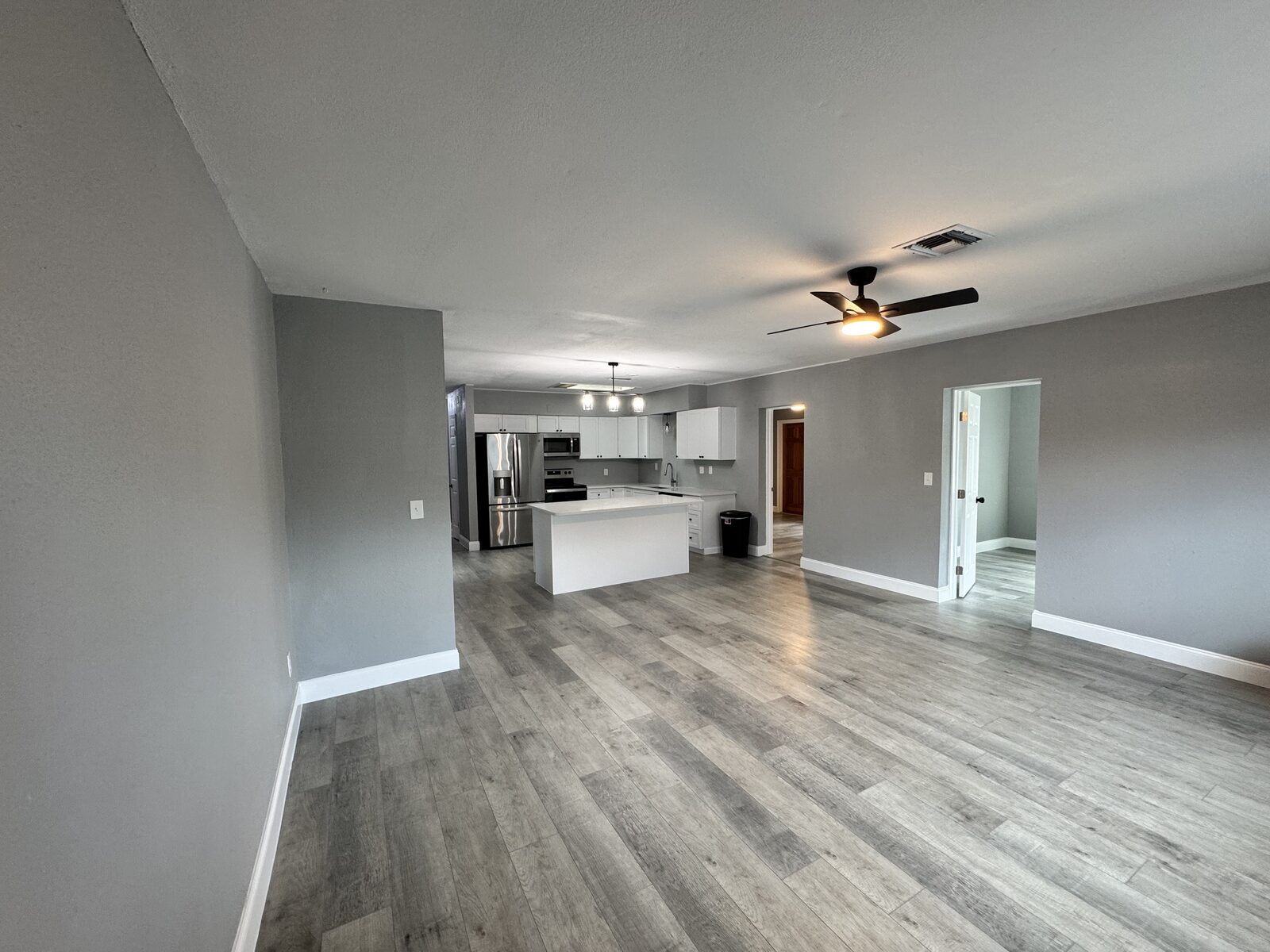 Great room and kitchen sightline with new plank flooring