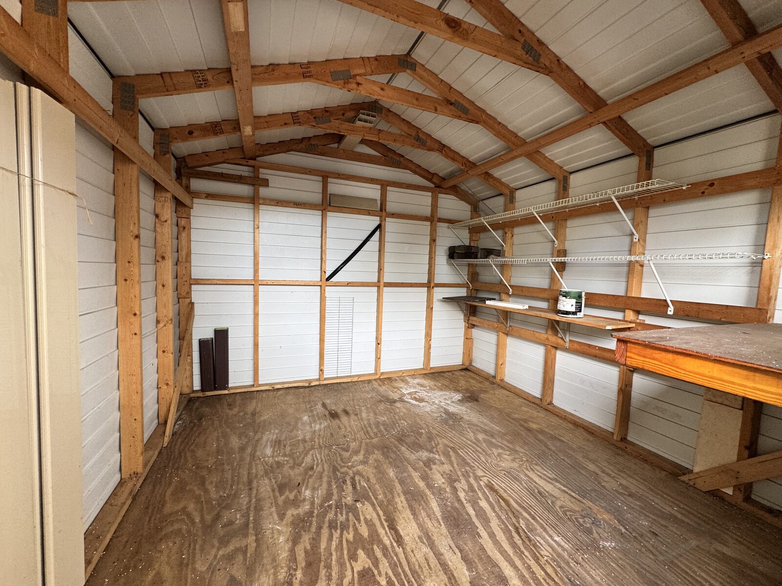 Workshop and storage shed interior with built-in workbench
